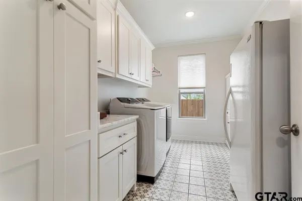 a kitchen with white cabinets and white appliances