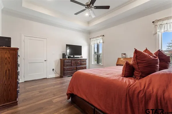 a bedroom with a bed dresser and a flat screen tv