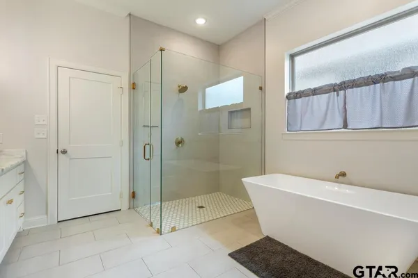 a bathroom with a bathtub and shower