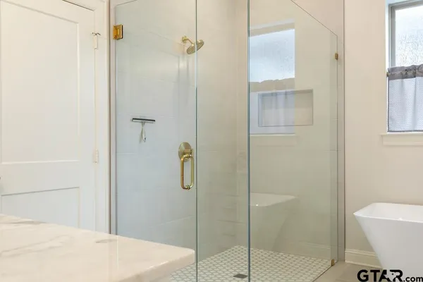 a bathroom with a shower and toilet