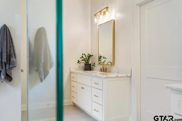 a bathroom with a double vanity sink and mirror