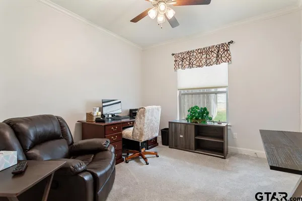 a work room with furniture and a potted plant