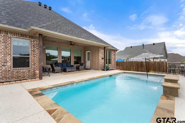 a swimming pool with outdoor seating