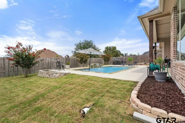 a view of a swimming pool with a patio