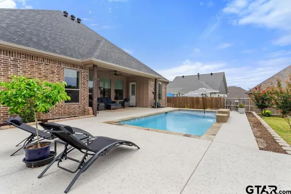 a view of a patio with swimming pool table and chairs