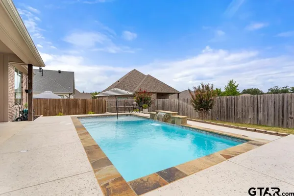 a view of a swimming pool with a lounge chairs