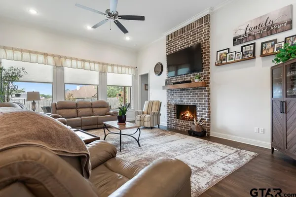 a living room with furniture a flat screen tv and a fireplace