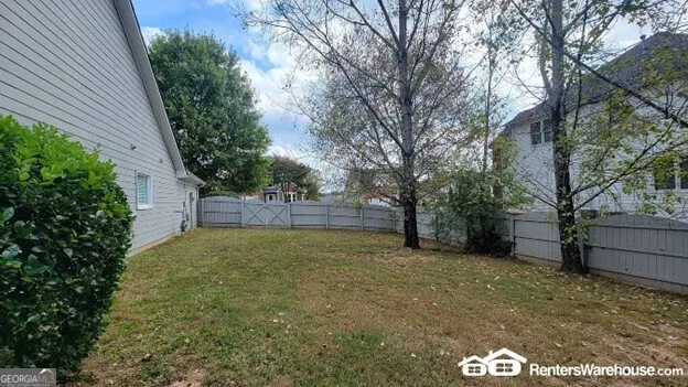 a view of a backyard with large trees