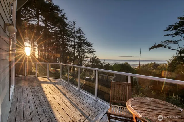 a view of balcony with wooden floor and fence