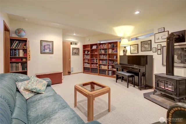 a living room with furniture a flat screen tv and a bookshelf