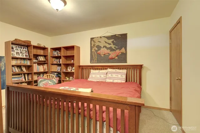 a bedroom with a bed and book shelf
