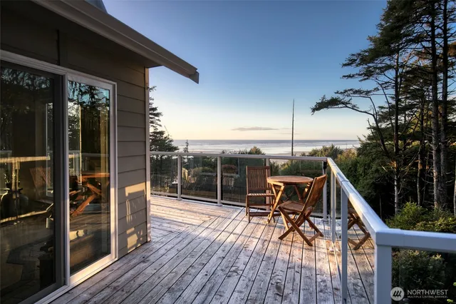 a view of deck with table and chairs with wooden floor and fence