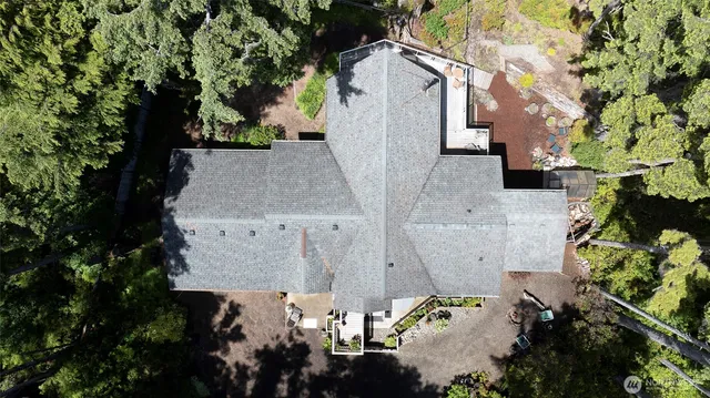 an aerial view of a house with a yard