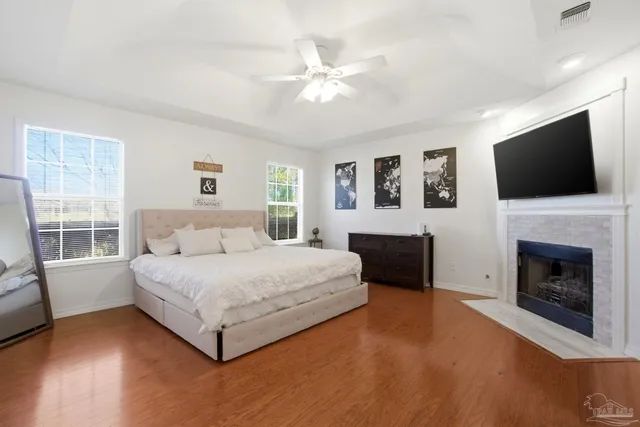 a spacious bedroom with a large bed and a flat screen tv