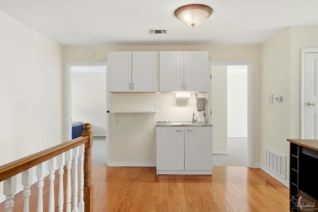 a bedroom with a bed and a chandelier fan