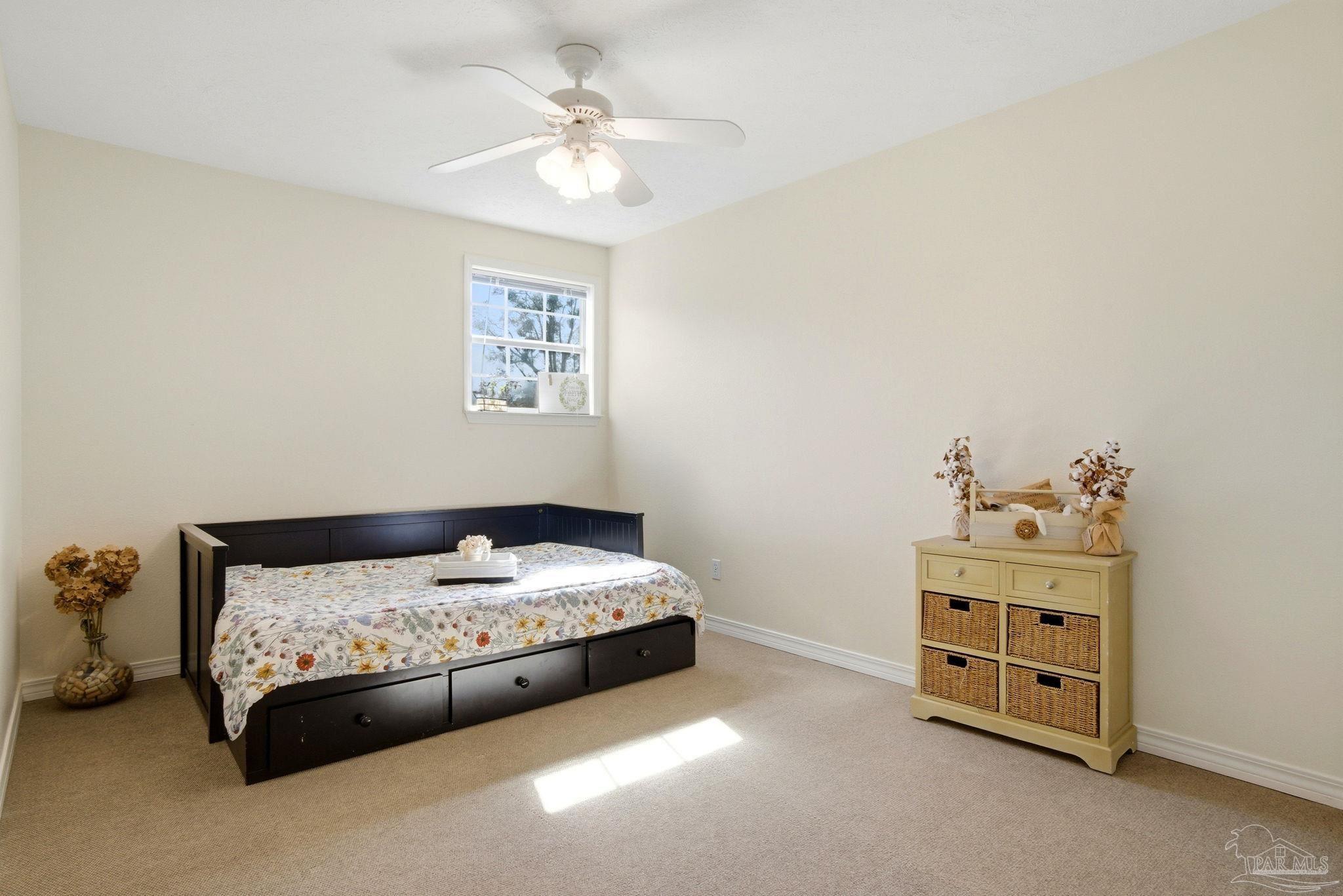 1805 West 10 Mile Road Pensacola, FL 32534 - Photo 17 of 61 a bedroom with a bed and a chair