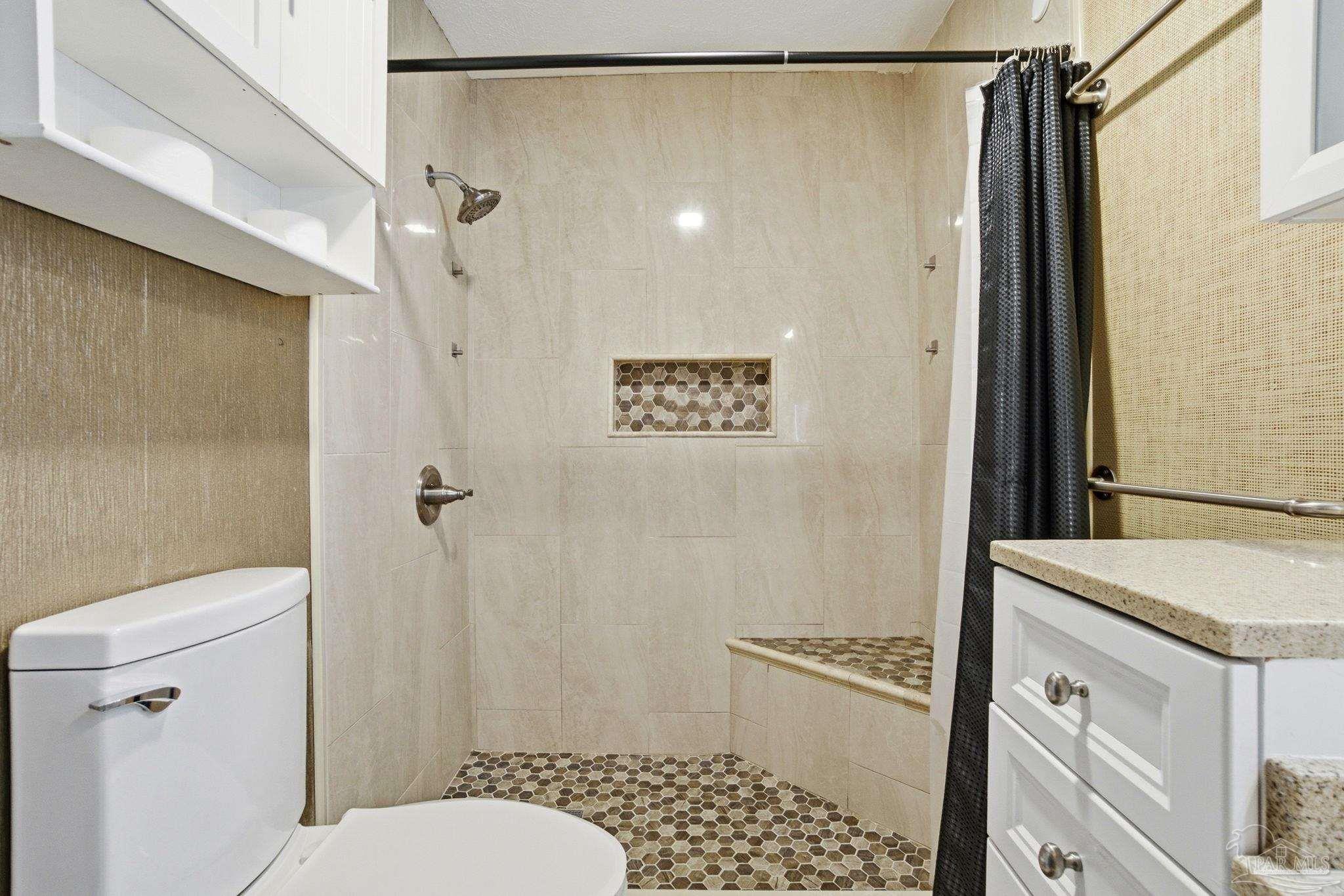 1805 West 10 Mile Road Pensacola, FL 32534 - Photo 24 of 61 a bathroom with a granite countertop shower toilet and sink