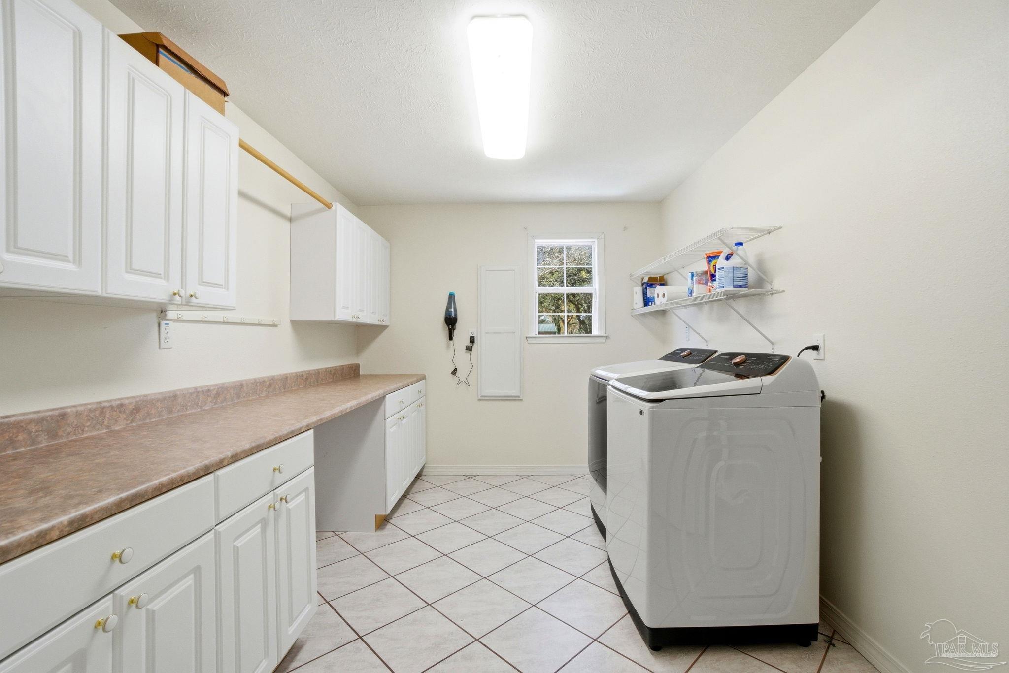 1805 West 10 Mile Road Pensacola, FL 32534 - Photo 30 of 61 a utility room with cabinets washer and dryer