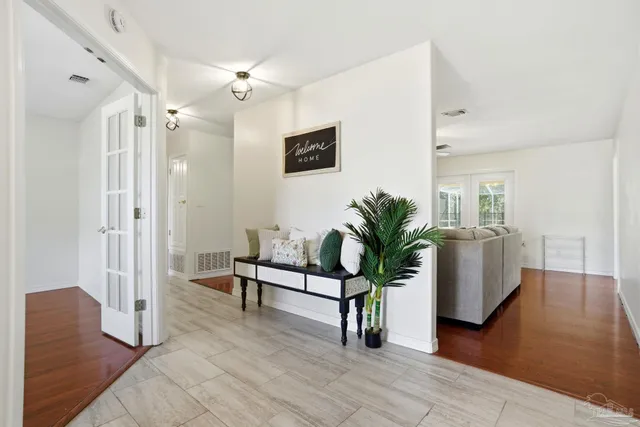 a view of empty room with wooden floor