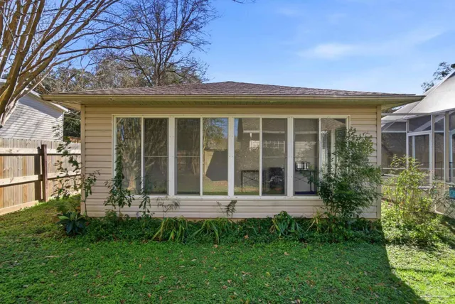 a view of a house with a yard and sitting area