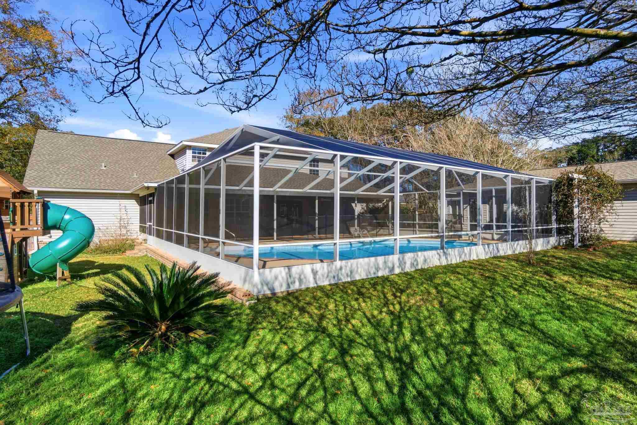 1805 West 10 Mile Road Pensacola, FL 32534 - Photo 47 of 61 a view of a house with a large window and potted plants