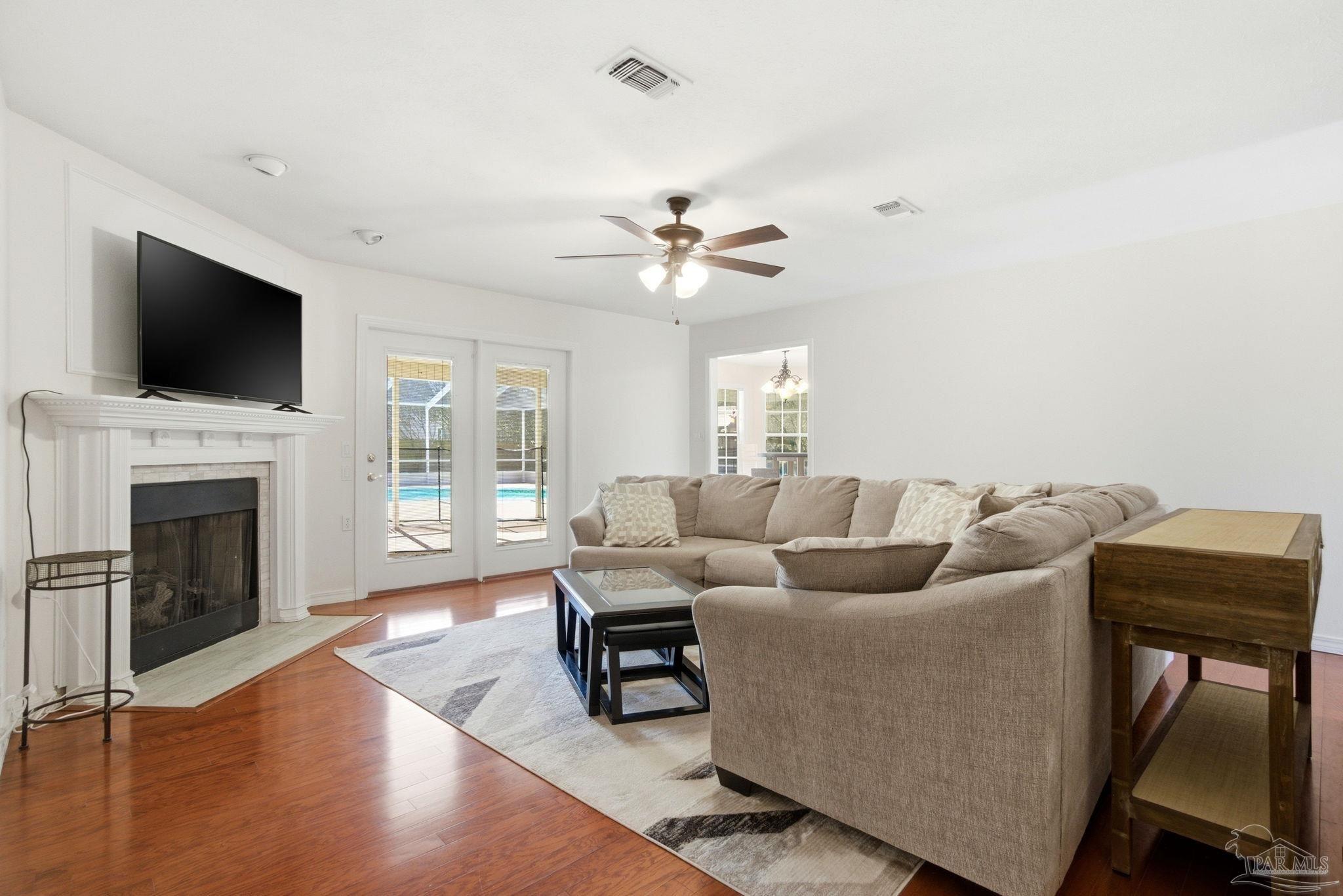 1805 West 10 Mile Road Pensacola, FL 32534 - Photo 6 of 61 a living room with furniture a fireplace and a flat screen tv