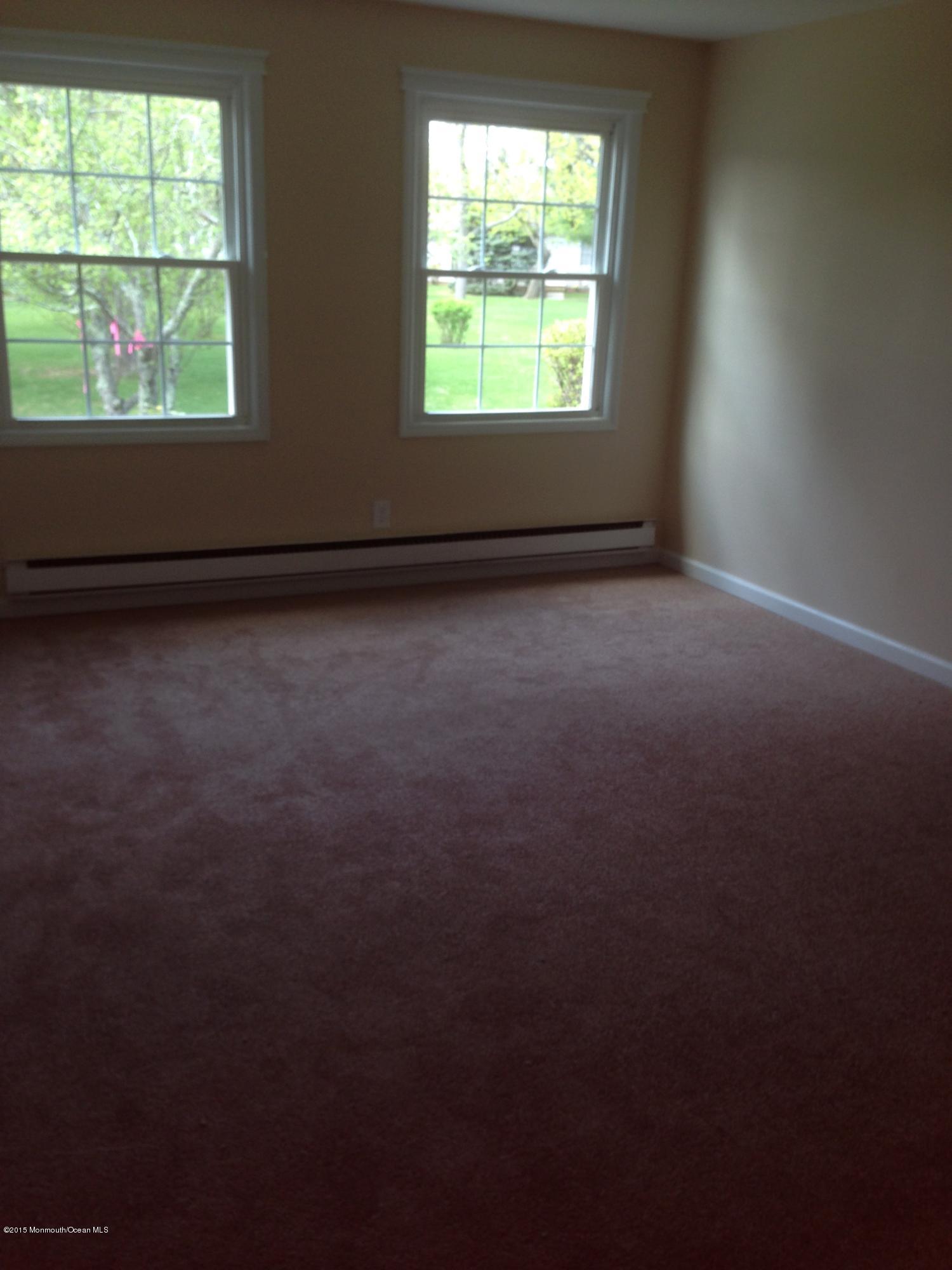 94 Halls Croft Road, Unit B Freehold, NJ 07728 - Photo 6 of 12 an empty room with a window