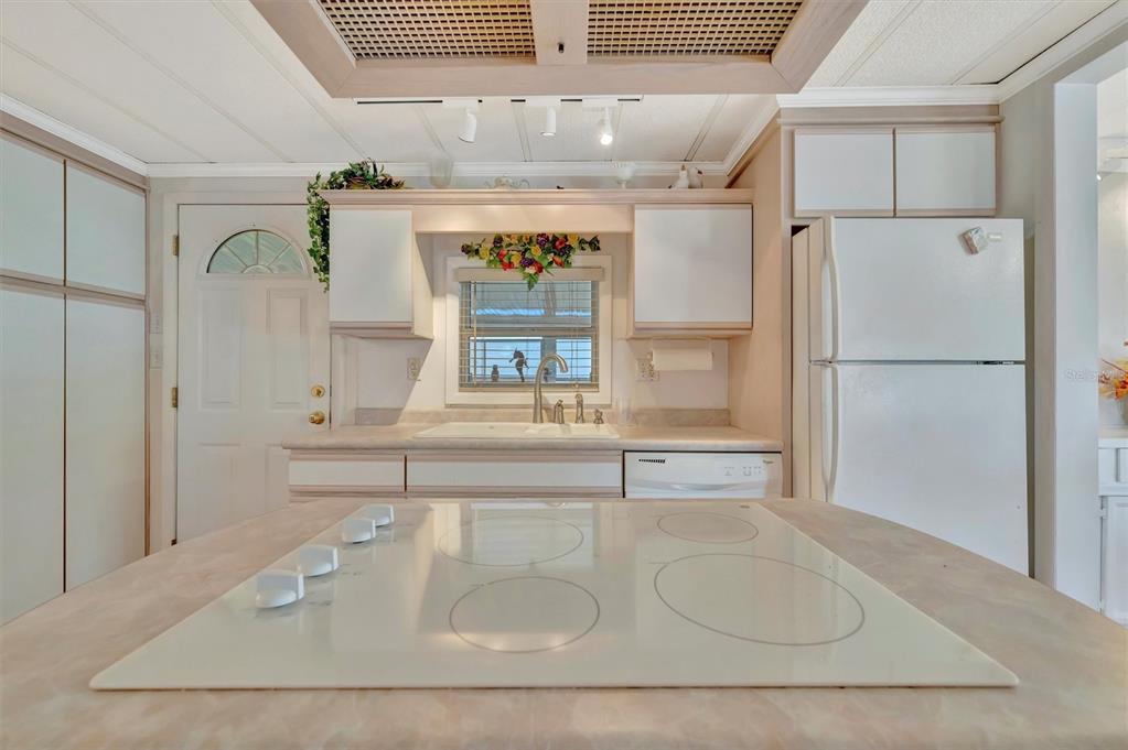 124 St Pierres Way Apollo Beach, FL 33572 - Photo 13 of 56 a kitchen with a refrigerator a sink and white cabinets