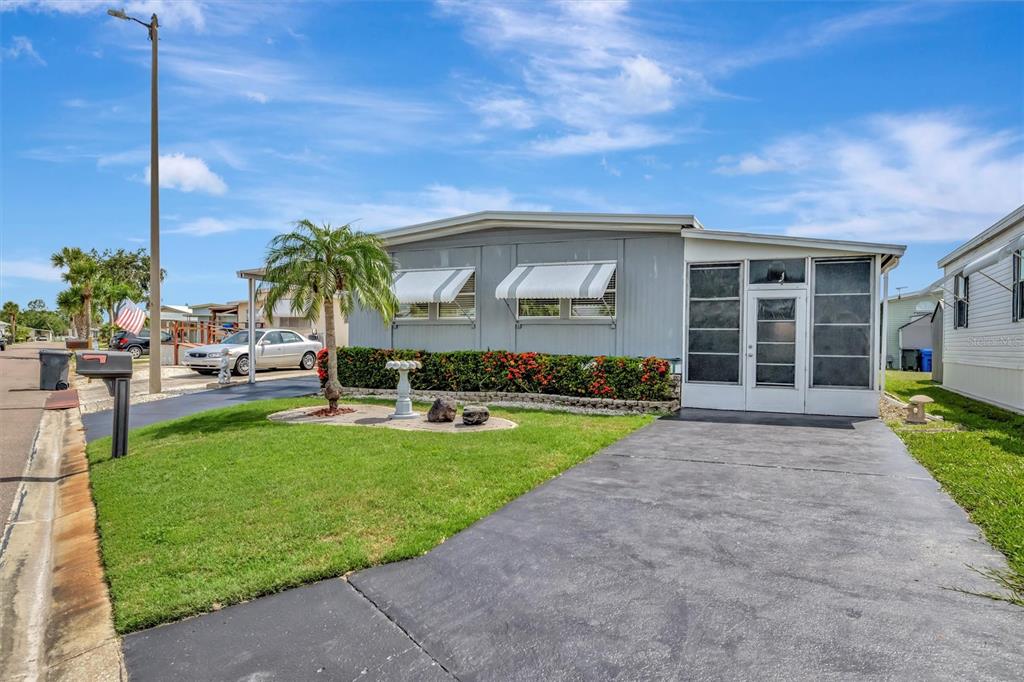 124 St Pierres Way Apollo Beach, FL 33572 - Photo 2 of 56 a front view of a house with a garden and yard