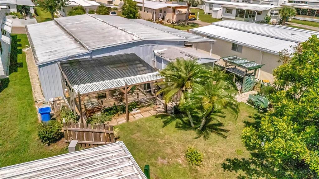 124 St Pierres Way Apollo Beach, FL 33572 - Photo 33 of 56 a view of a patio with table and chairs with wooden floor and fence