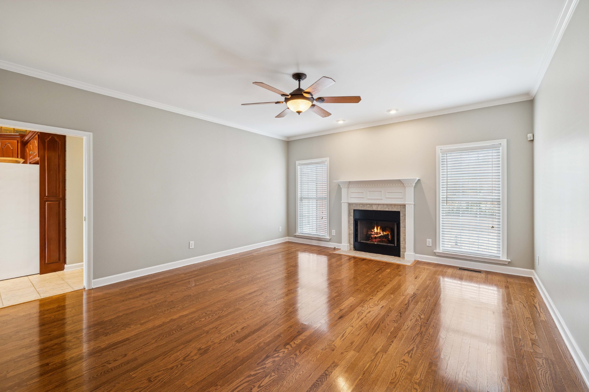 1205 Rock Springs Road Smyrna, TN 37167 - Photo 6 of 48 a view of a livingroom with a fireplace a ceiling fan and windows