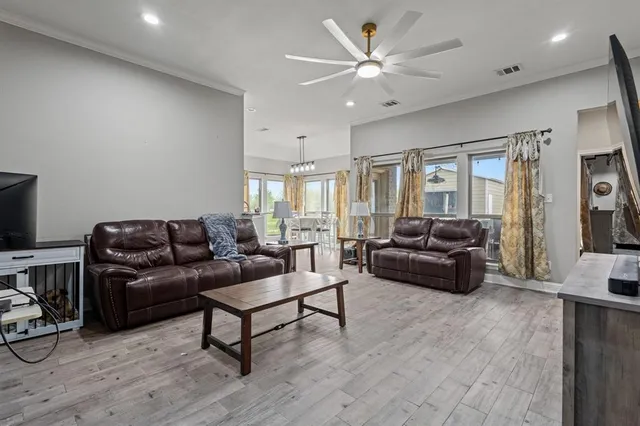 a living room with furniture a ceiling fan and a rug