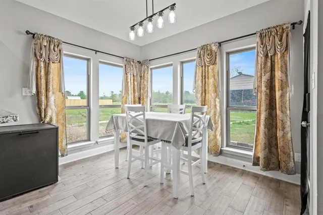 a view of a dining room with furniture and windows
