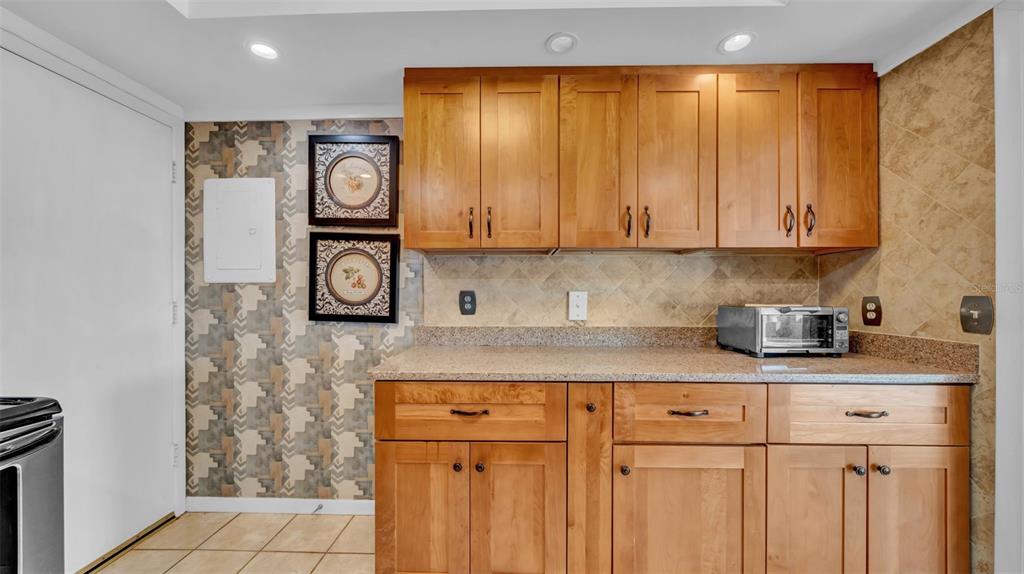 17400 Gulf Boulevard, Unit J7 Redington Shores, FL 33708 - Photo 18 of 32 a kitchen with stainless steel appliances granite countertop a sink and cabinets