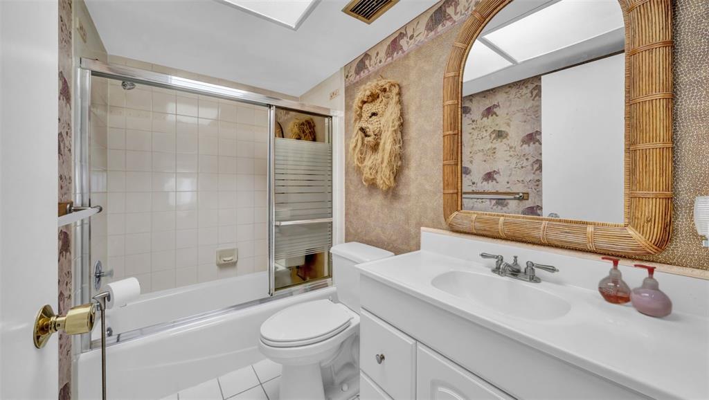 17400 Gulf Boulevard, Unit J7 Redington Shores, FL 33708 - Photo 19 of 32 a bathroom with a sink a toilet and shower