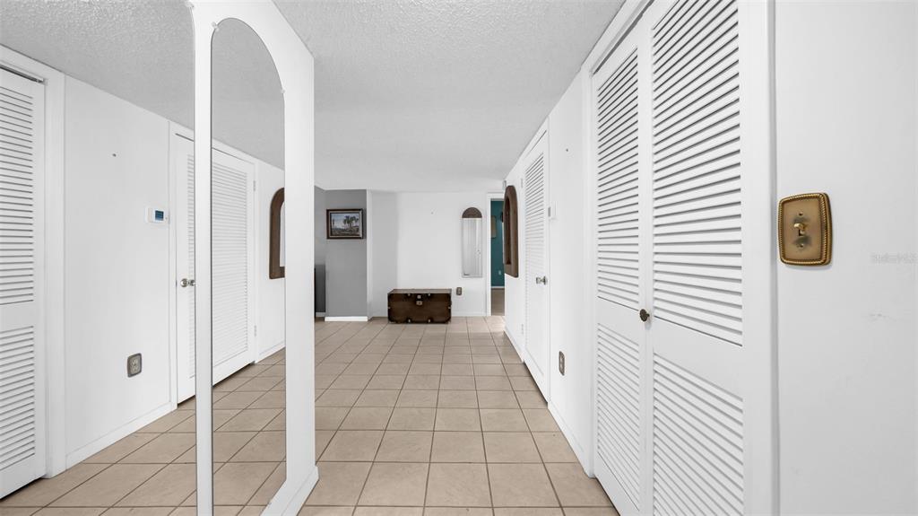 17400 Gulf Boulevard, Unit J7 Redington Shores, FL 33708 - Photo 6 of 32 a view of a hallway with entryway wooden floor and cabinet