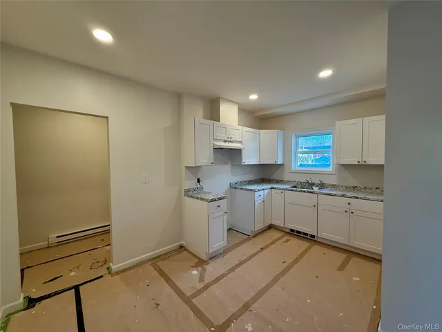 a view of a hallway with wooden shelves