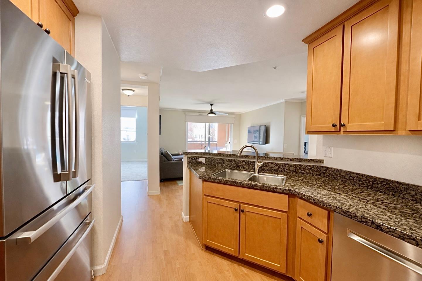 1310 Saddle Rack Street, Unit 347 San Jose, CA 95126 - Photo 14 of 42 a kitchen with stainless steel appliances granite countertop a refrigerator and a sink