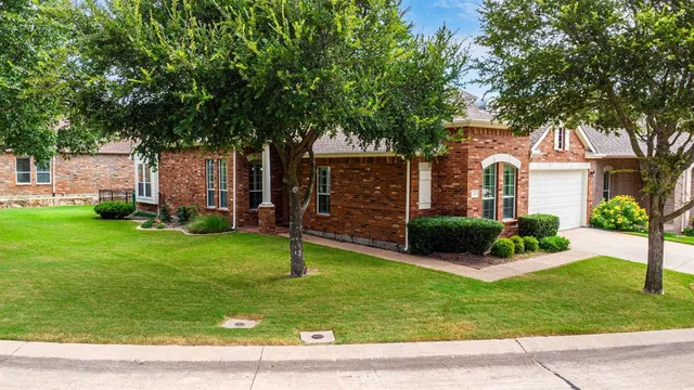 a front view of a house with a garden and yard