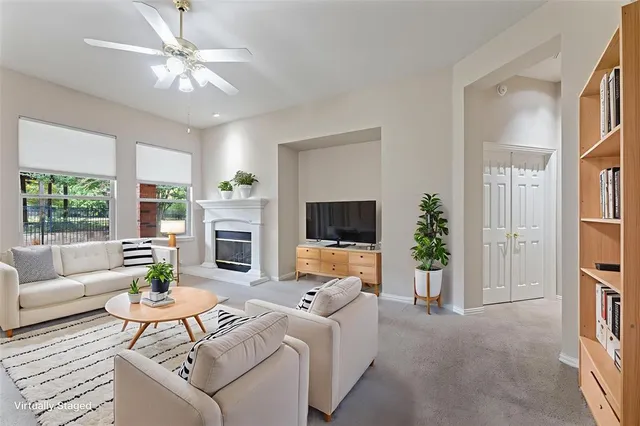 a living room with furniture a flat screen tv and a large window