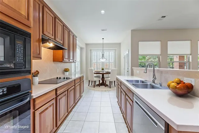 a large kitchen with stainless steel appliances lots of counter space and breakfast area