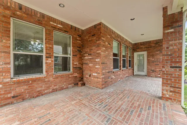 an aerial view of a house with a yard basket ball court and outdoor seating