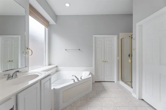 a bathroom with a double vanity sink a mirror and shower