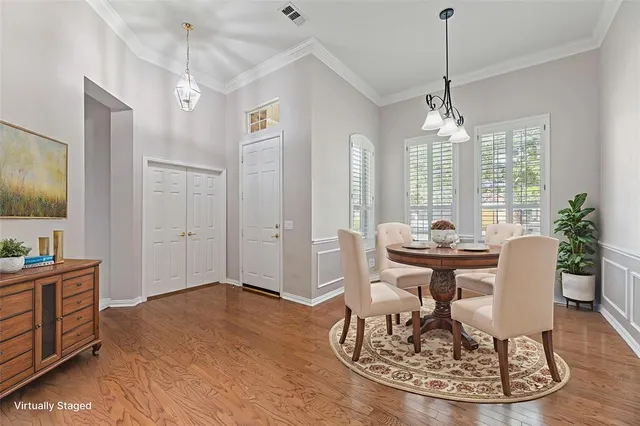 a view of a dining room with furniture window and wooden floor