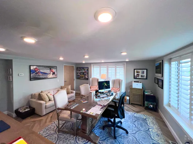 a living room with furniture a rug and a window