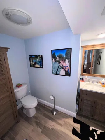a bathroom with a toilet and a mirror