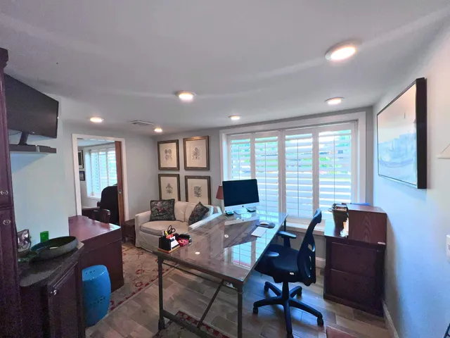 a living room with furniture and large windows