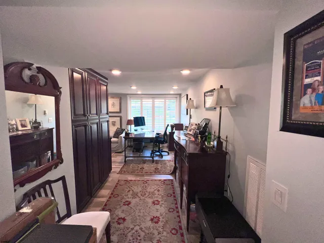 a view of a hallway with couch and chairs
