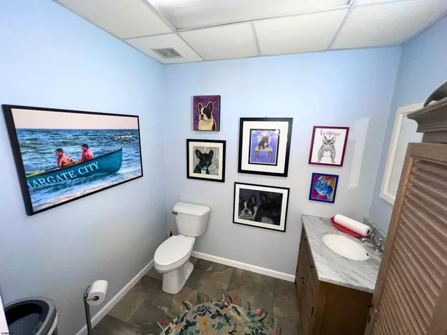 a living room with furniture and a painting on the wall