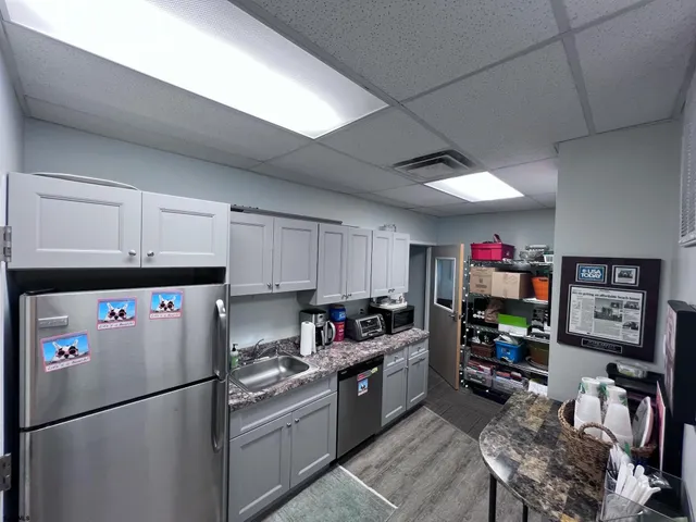a kitchen with stainless steel appliances granite countertop a refrigerator sink and a stove